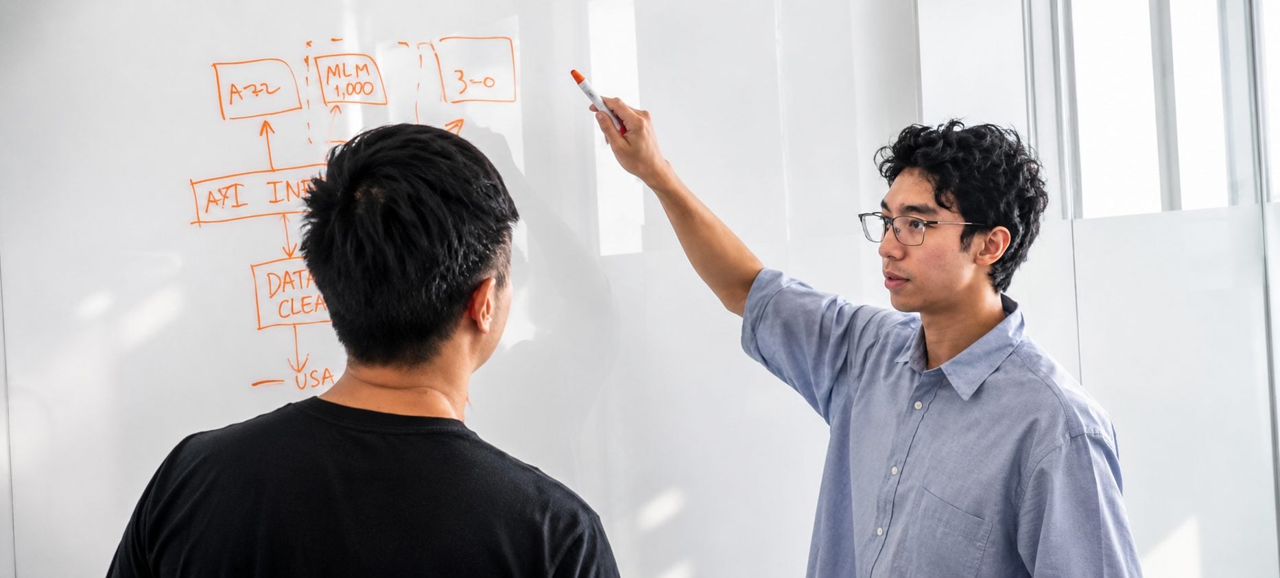 An engineer sketching an AI pipeline on a whiteboard during a ChipAgents training session