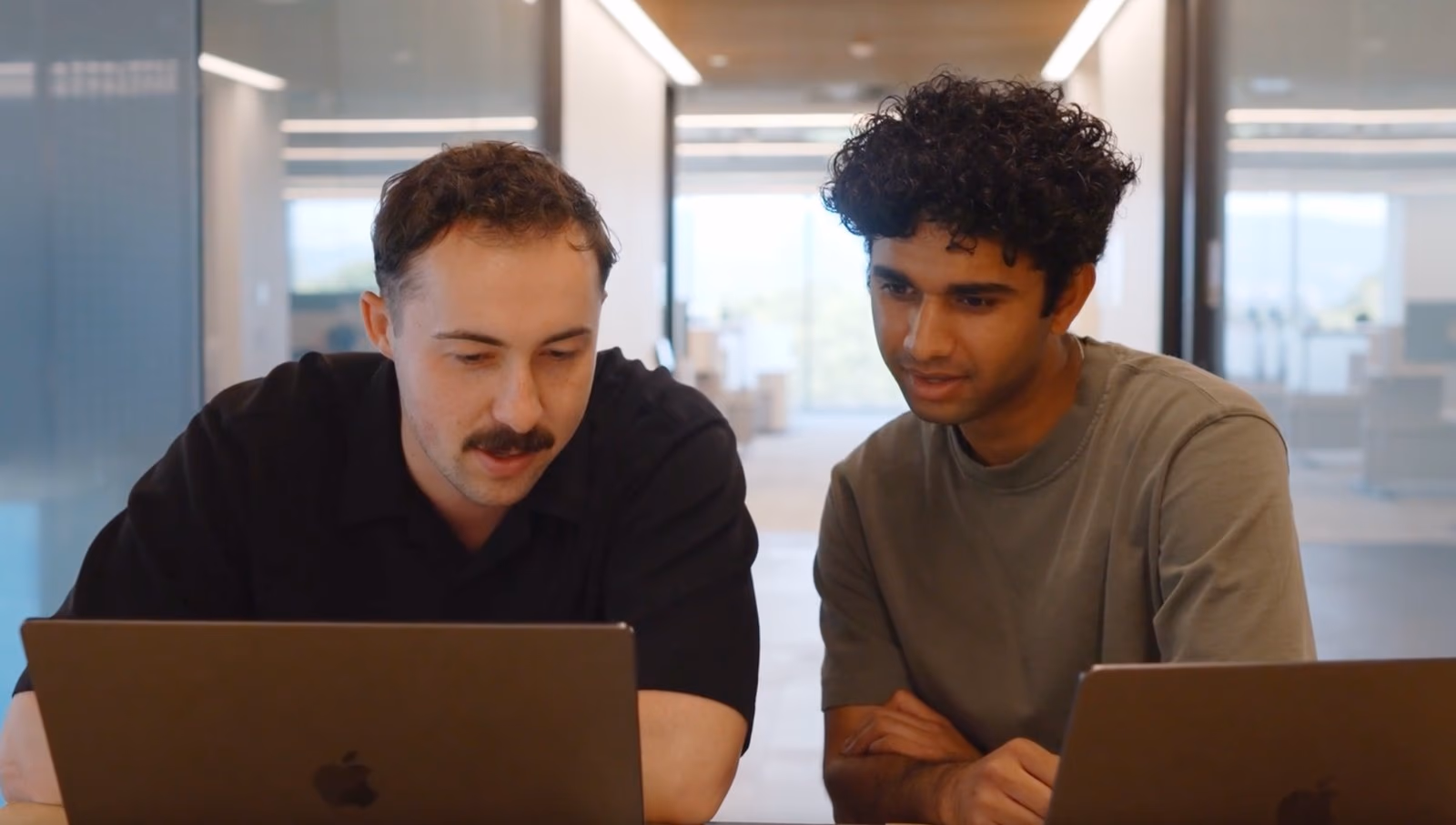 Two ChipAgents engineers working together at their laptops